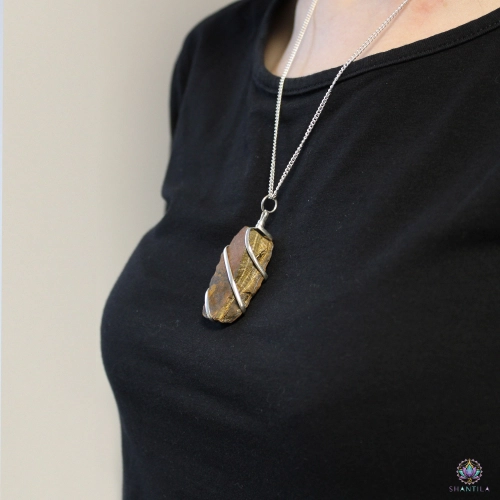 Pendentif Œil de Tigre Brut en Spirale — Chaîne 50 cm 3 Pendentif œil de tigre brut en spirale porté sur un haut noir, le pendentif tombant sous les clavicules