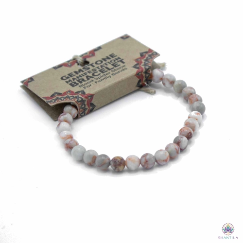 Bracelet Perles Blood Spider Stone — Liens Familiaux 2 Bracelet blood spider stone enfilé sur sa carte kraft illustrée « Gemstone Manifestation Bracelet »