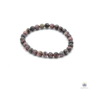 Bracelet jaspe peau de léopard : perles gris-brun tachetées de rose et de noir, posé à plat sur fond blanc