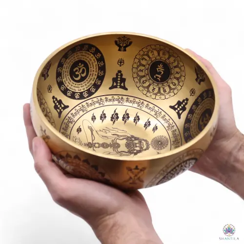 Set de 4 Bols Chantants Laiton Gravés Yogi et Chakras – Emboîtables, Sans Maillet 7 Le plus grand des quatre bols tenu à deux mains, yogi gravé au fond et médaillons Om sur la paroi
